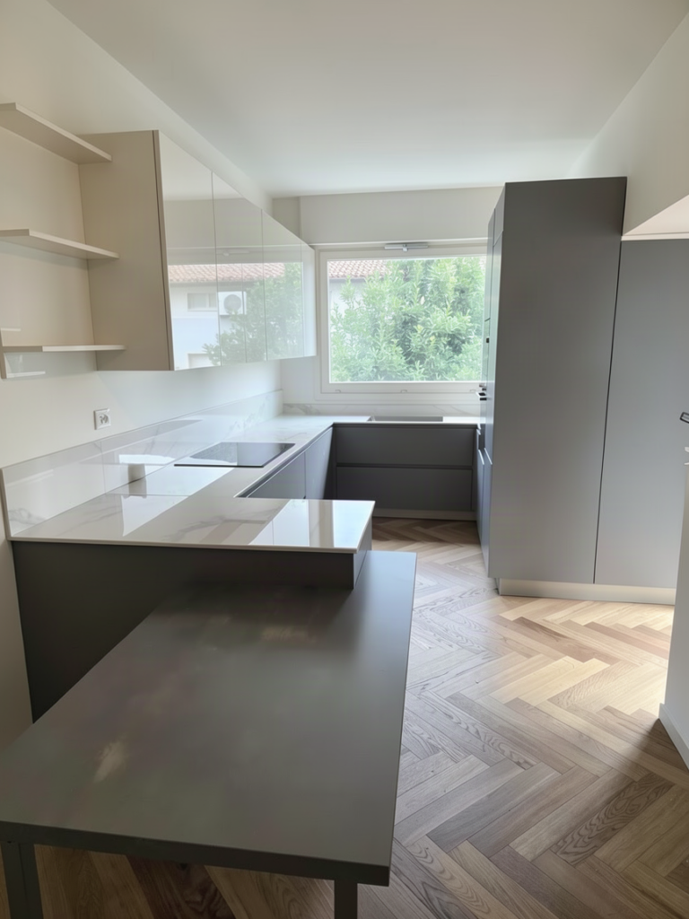 Cucina a U con piano effetto marmo, penisola e piano cottura a induzione, su parquet a spina